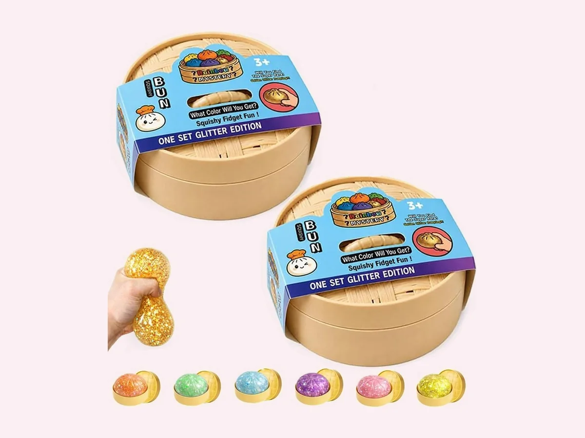 Glitter-filled translucent dumpling squishy in a steamer-style tray