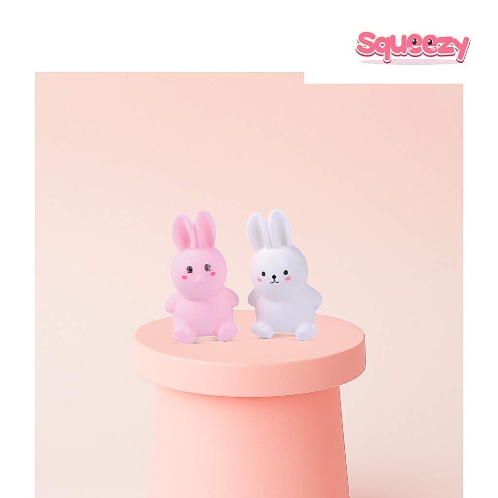 Pink & White EVA Rabbit Soft being squeezed